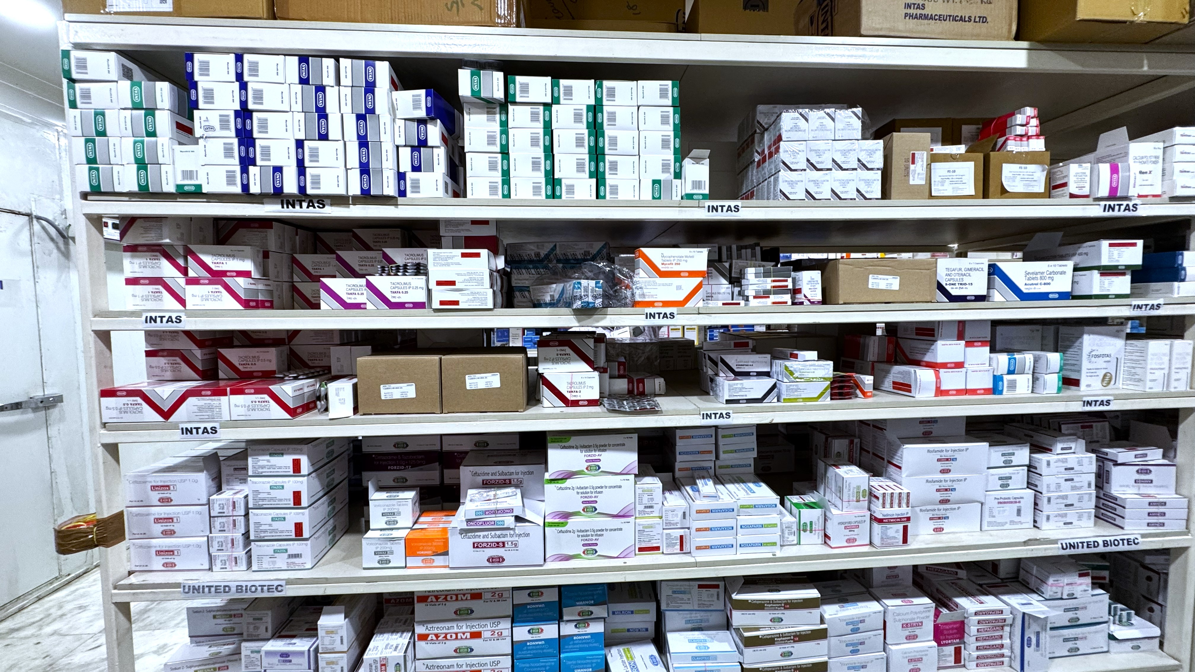 Modern pharmaceutical warehouse with organized medicine shelves